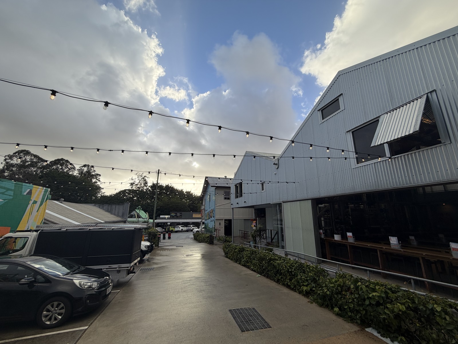 Festoon lighting strung across a venue laneway on the Sunshine Coast