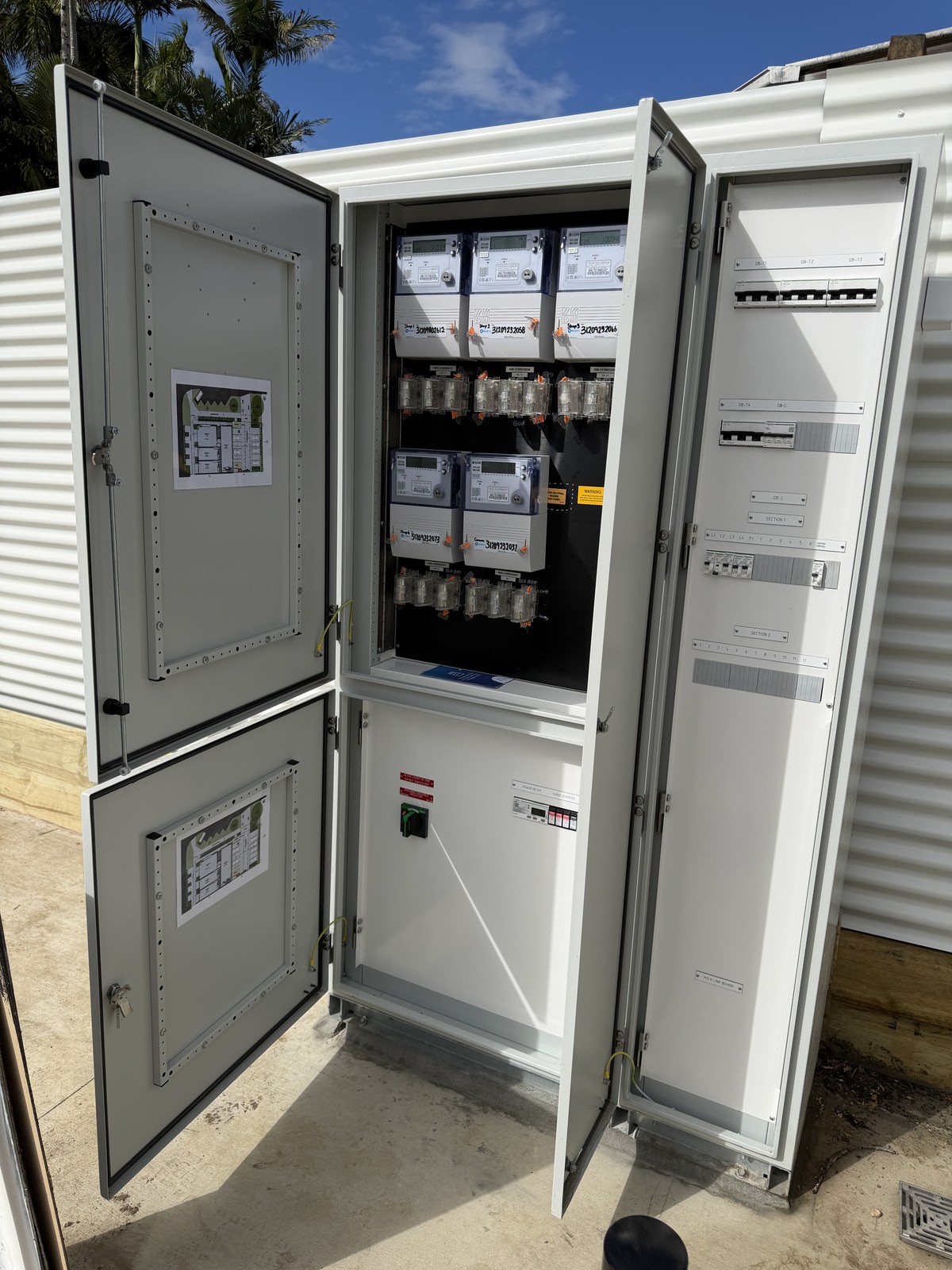 Multi-tenancy main switchboard and metering cabinet with site plans mounted in the doors